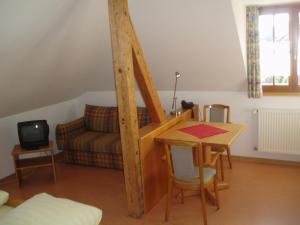 ein Wohnzimmer mit einem Tisch und einem Sofa in der Unterkunft Lotus Garden in Gailingen