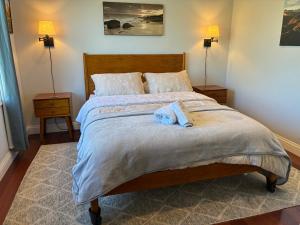 a bedroom with a bed with a blue towel on it at Private bedroom and bathroom in Rancho Santa Margarita