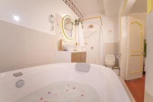 a white bathroom with a tub and a sink at Posada del Angel in Salento +239 photos