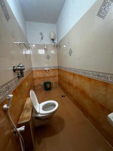 a bathroom with a toilet and a sink at IP Home stays in Pondicherry