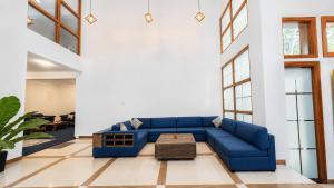 a living room with a blue couch and a table at Hasthi Boutique in Kandy