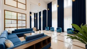 a living room with a blue couch and blue chairs at Hasthi Boutique in Kandy