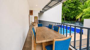 a table and chairs on a balcony with a pool at Hasthi Boutique in Kandy +50 photos