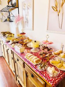 a buffet with many different types of food on it at Pink Village Boutique in Campos do Jordão
