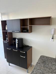 a kitchen with a counter with a coffee maker on it at Casa próx senai e quartel in Três Lagoas