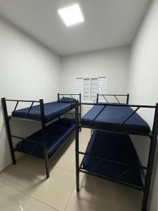 two bunk beds in a room with a ceiling at Casa próx senai e quartel in Três Lagoas
