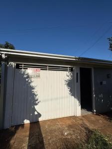 a building with a garage door with a tree projected on it at Casa próx senai e quartel in Três Lagoas +7 photos