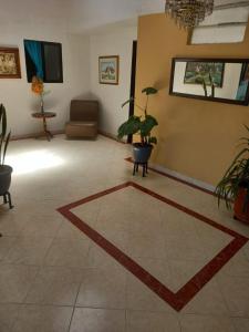 a living room with a rug on the floor at Hotel Oriente Real in Rionegro +14 photos