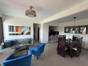 a living room with a couch and a table and chairs at Torre con ascensor y vigilancia in Santiago de los Caballeros