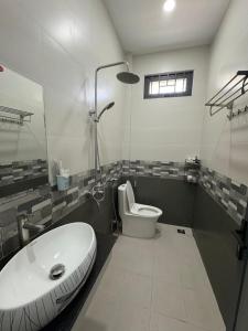 a bathroom with a white sink and a toilet at The Sweet Home in Nha Trang