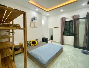 a bedroom with a bed and a bunk bed at The Sweet Home in Nha Trang