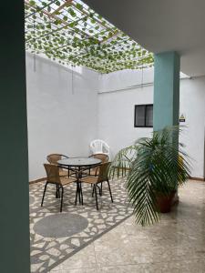 a table and chairs in a room with a plant at Hotel Oriente Real in Rionegro