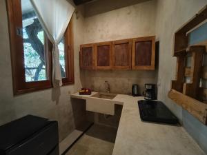 a small kitchen with a sink and a window at La Casa de Mia Holbox in Holbox Island +115 photos