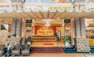 a restaurant with a bar in a building at Tran Vinh Hotel in Bạc Liêu