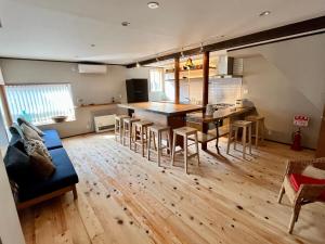 a kitchen and living room with a table and chairs at NouHarborVilla in Itoigawa