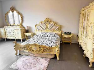 a bedroom with a gold bed and two mirrors at NEW Spacious BR with Ensuite Bathroom in Innisfil