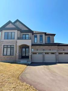a large brick house with two garages at NEW Spacious BR with Ensuite Bathroom in Innisfil