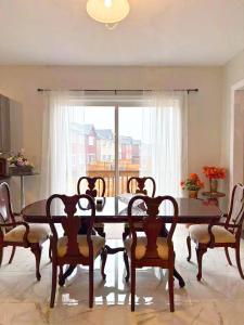 a dining room with a table and chairs and a window at NEW Spacious BR with Ensuite Bathroom in Innisfil