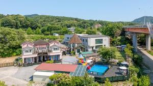 an aerial view of a house with a pool at Chuncheon Remember Pet Pension in Chuncheon