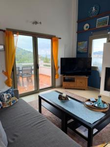 a living room with a couch and a coffee table at Skiathos Seaview Villa with Pool in Punta
