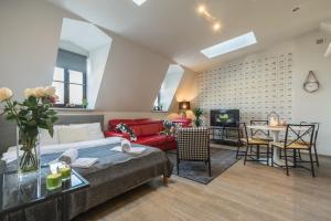 a living room with a couch and a table at 7 Koron - Exclusive Apartments in Krakow