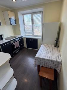 a small kitchen with a table in a room at Квартира ЛЮКС in Balqash