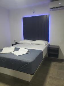 a bedroom with a bed with two towels on it at Lacosta Josss in Acapulco