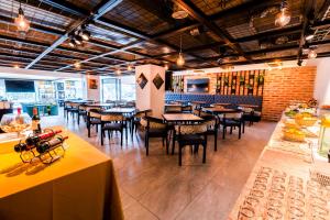 a restaurant with tables and chairs and a brick wall at Wyndham Garden Quito in Quito