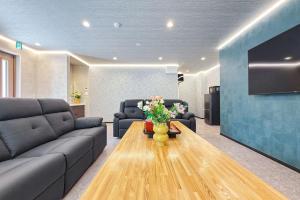 a living room with a couch and a table at 富士見莊sl0582 in Oshino