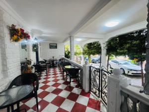 a porch with chairs and tables and a car parked at Twins Kobuleti in Kobuleti +33 photos