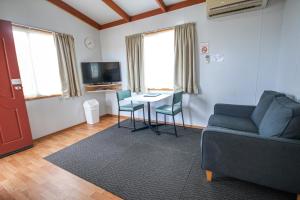 a living room with a couch and a table with chairs at Horsham Holiday Park in Horsham