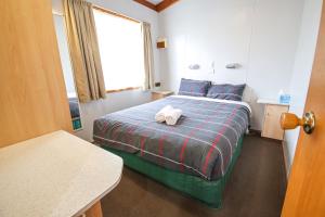 a bedroom with a bed with two towels on it at Horsham Holiday Park in Horsham +24 photos