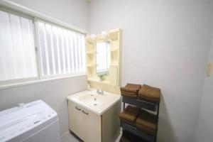a white bathroom with a sink and a mirror at 春日レジャーホテル in Fukuoka +46 photos