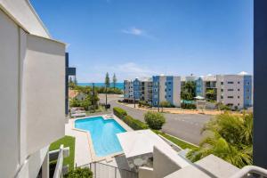 a view of the pool from the balcony of a apartment at Warroo Apartments in Alexandra Headland