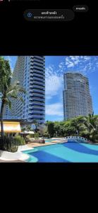 a picture of a swimming pool with two tall buildings at Beautiful 1bedroom 35sqm sea view floor17th jomtien Lumpini in Jomtien Beach
