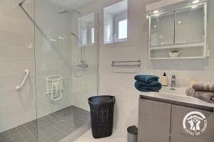 a bathroom with a glass shower with a sink and a toilet at De la roche in Langourla +39 photos