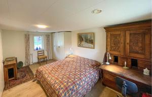 a bedroom with a bed and a dresser and a desk at Beautiful Home In Øster Ulslev With Wifi in Øster Ulslev +6 photos