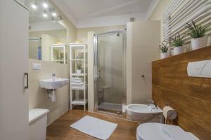 a bathroom with a shower and a toilet and a sink at 7 Koron - Exclusive Apartments in Krakow