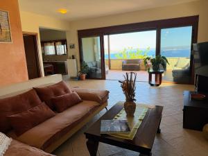 a living room with a couch and a table at Bliss House Villa in Plaka +69 photos