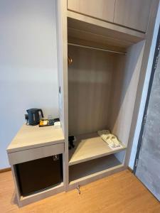 a cupboard in a room with a counter and a kitchen at DBC Hotel in Semporna