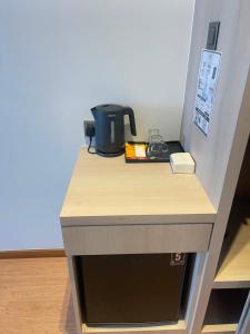 a counter with a coffee pot on top of it at DBC Hotel in Semporna