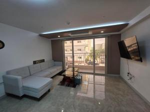a living room with a couch and a flat screen tv at clark terrace condo with 2bedroom near airport hann casino in Tibo