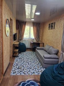a living room with a couch and a table at Гостевой дом Chimgan Apple Garden in Chimgan