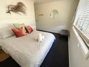 a bedroom with a bed with a teddy bear on it at Arcos in Hat Head