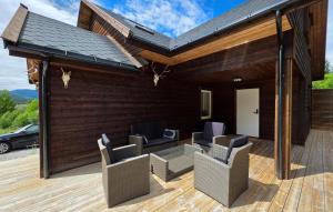 a patio with chairs on a wooden deck at Stunning Home In Treungen in Treungen +11 photos
