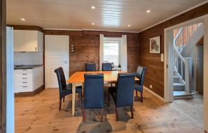 a kitchen and dining room with a table and chairs at Stunning Home In Treungen in Treungen