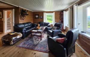 a living room with leather furniture and a table at Stunning Home In Treungen in Treungen