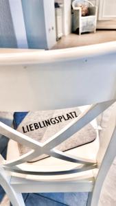 a white chair with a sign on it at Black Forest Hideaway in Gernsbach