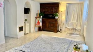 a living room with a bed and a chair at Black Forest Hideaway in Gernsbach