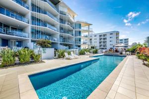 an image of a swimming pool in front of a apartment building at C Bargara Unit 101 in Bargara